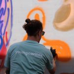 Participants spray on canvases