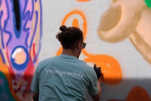 Participants spray on canvases